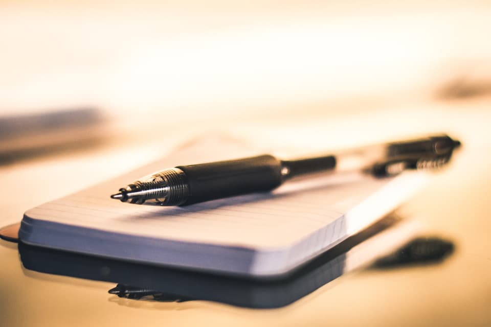 Pen resting on a notepad, symbolizing the documentation work carried out by a data protection officer